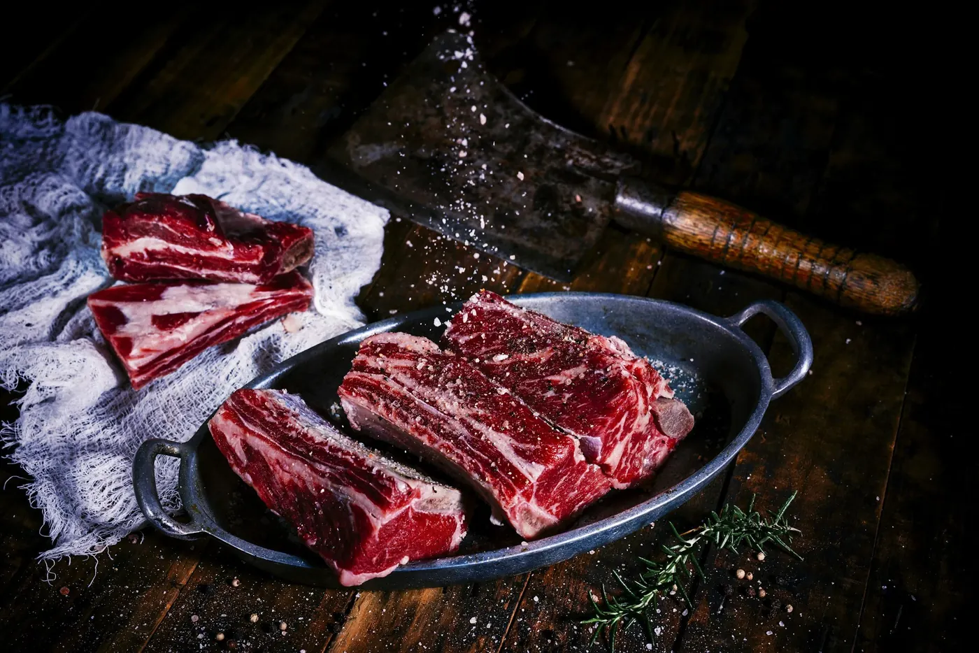W9 beef ribs and cuts on a rustic surface